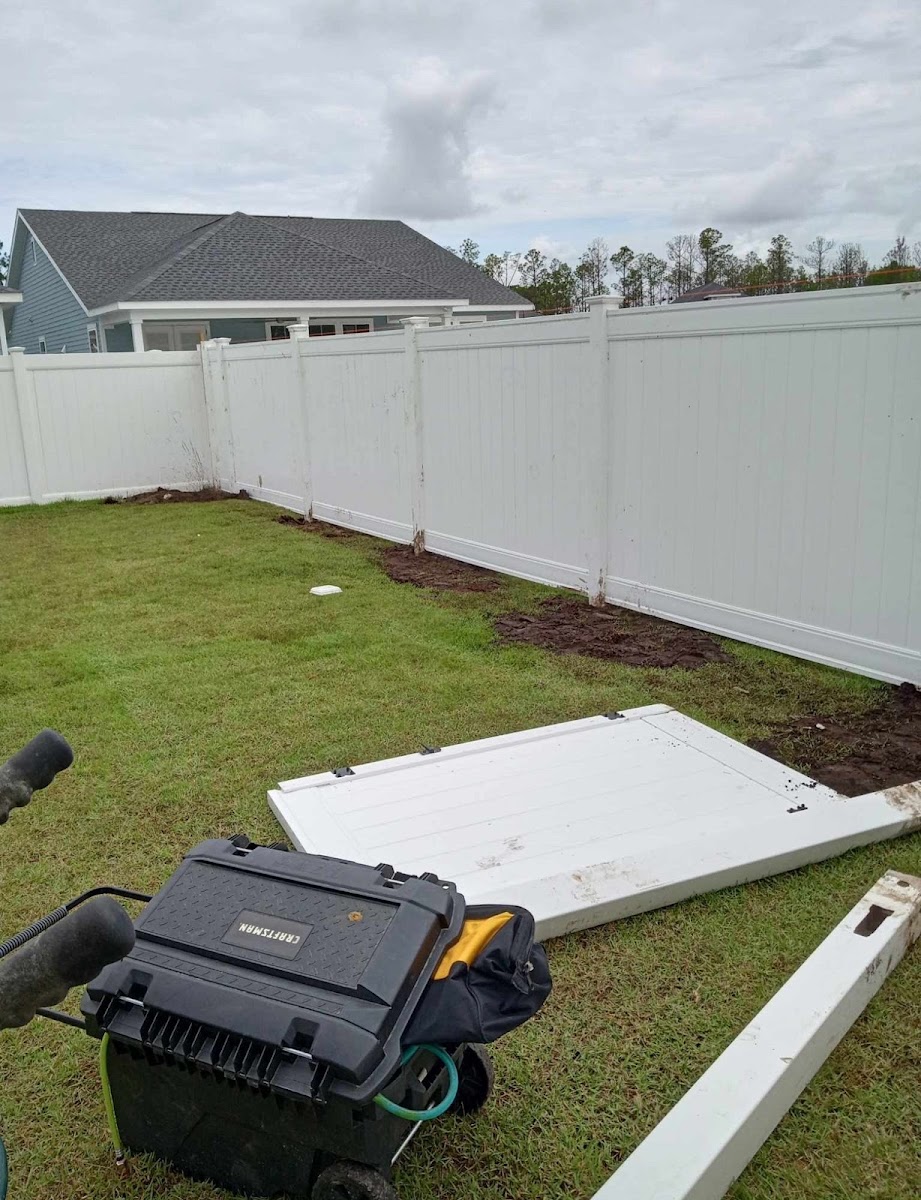 White vinyl fence installation in progress