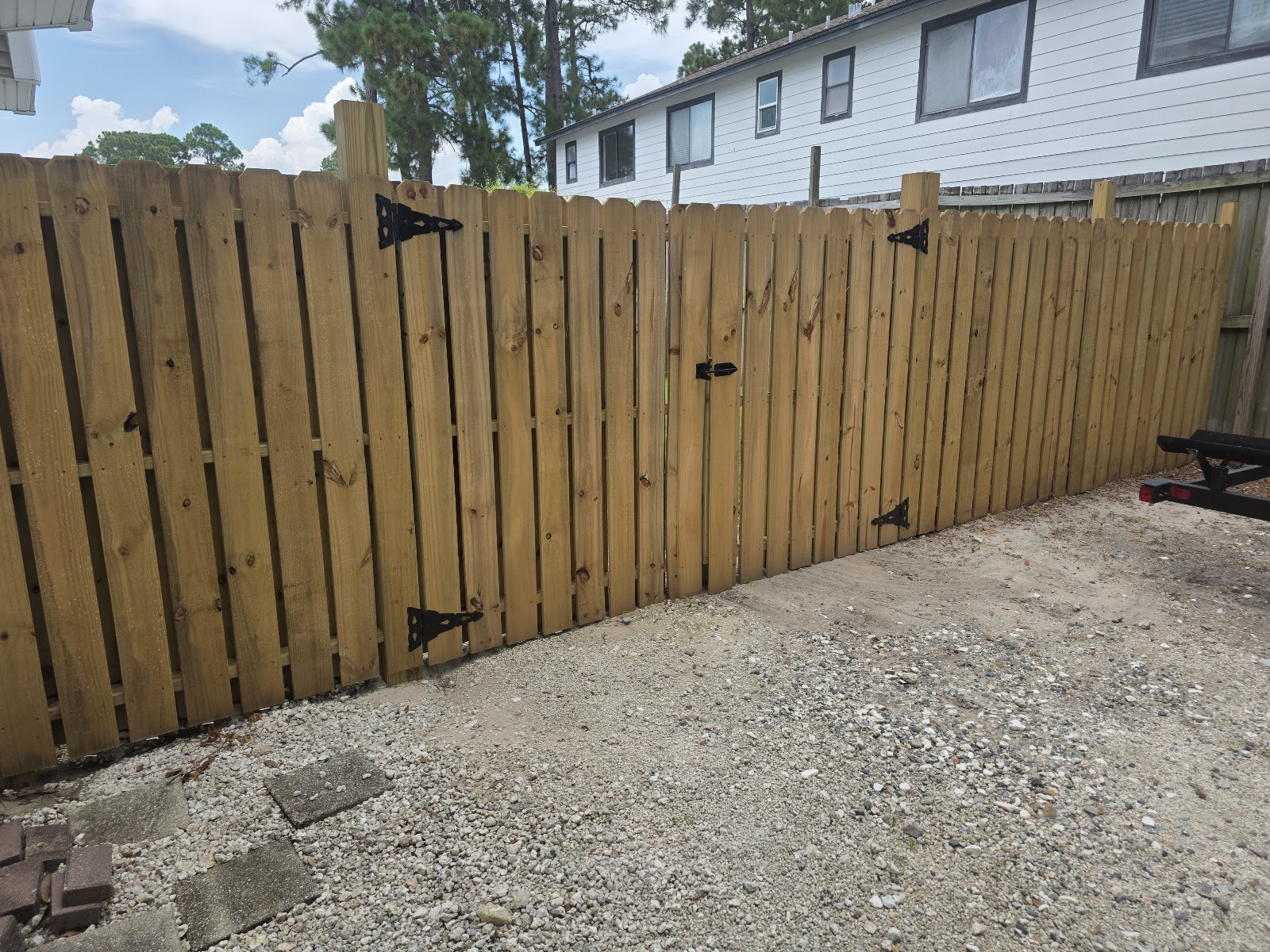 Finished wooden privacy fence with double gate