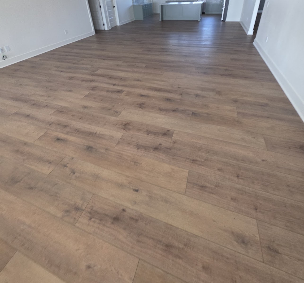 Wood-look plank flooring installed across an open room